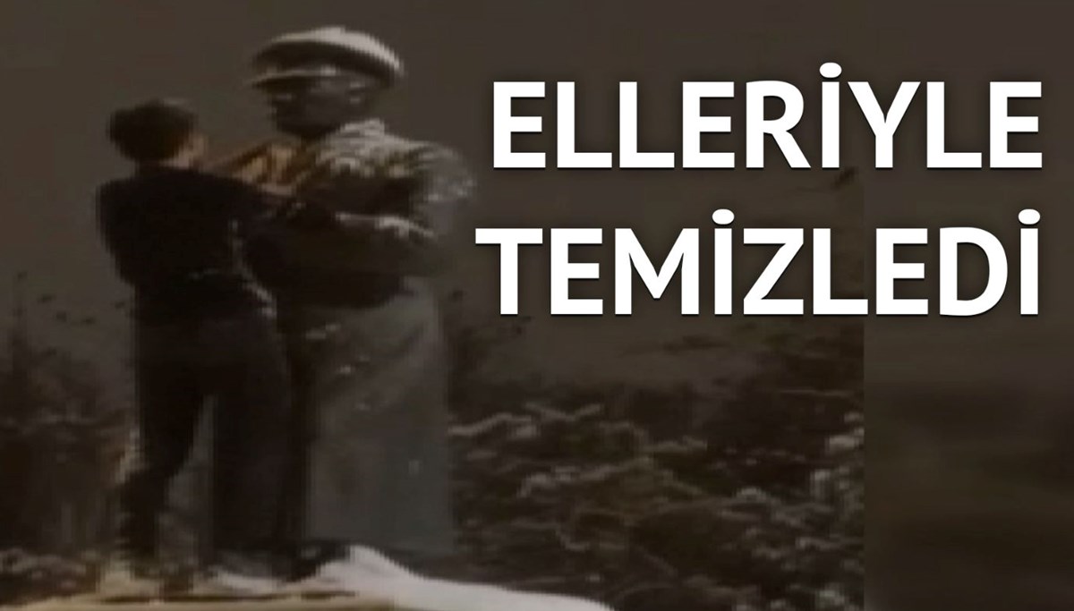 Kar altındaki Atatürk heykelini elleriyle temizledi